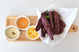 Baked Ube Wedges Recipe on Wood Board with Sauces | Vitacost.com/blog