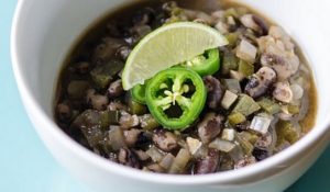 Bowl of orca bean chili garnished with jalepeno peppers and lime wedge | Vitacost.com/Blog