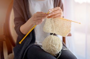 Woman Knitting Scarf to Donate to Charity for GivingTuesday | Vitacost.com/blog