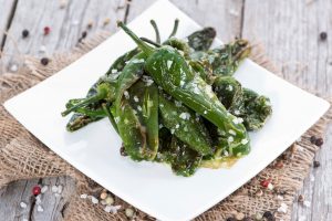 Blistered jalapeno peppers on white plate #blisteredpeppers #jalapenorecipes | Vitacost.com/blog