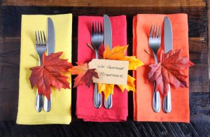 Thanksgiving Place Setting With Autumn-Colored Napkins and Silverware on Wooden Table | Vitacost.com/blog