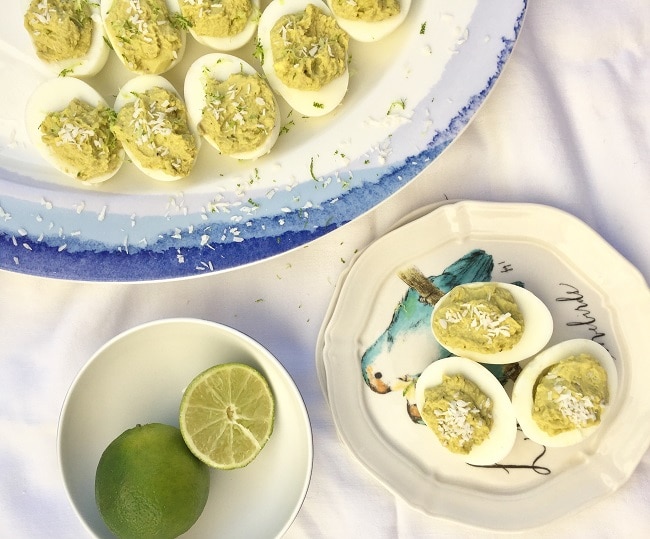 Avocado Deviled Eggs on Serving Platter with Bowl of Limes #appetizers | Vitacost.com/blog