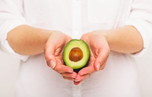 Woman Following The Paleo Diet Holding Avocado in Cupped Hands | Vitacost.com/blog