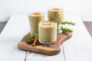 3 Glasses of Vegan Eggnog with Cinnamon Sticks on Wood | Vitacost.com/blog