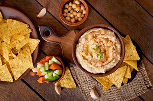 Simple Homemade Hummus with Corn Chips & Veggies on Wood #recipe | Vitacost.com/blog
