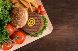 Meat Alternative Veggie Burger on Platter with Tomatoes and Fries | Vitacost.com/blog