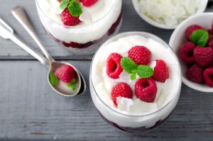 Whipped coconut cream in glass cup with raspberries #vegan | Vitacost.com/blog