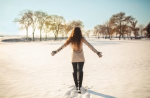 Woman Following Winter Safety Tips Walking Carefully in Fresh-Fallen Snow | Vitacost.com/blog