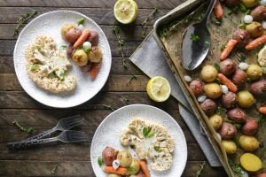 Cauliflower steaks on plates with roasted vegetables #cauliflowersteak | Vitacost.com/blog