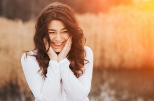 Woman Who Joined the No-Makeup Movement Holding Her Face in a Field | Vitacost.com/blog