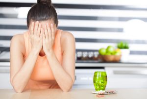 Woman Covering Face Dreading Taking Her Daily Vitamins and Minerals | Vitacost.com/blog