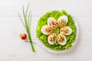 Deviled Eggs Stuffed with Smoked Salmon Cream Cheese Topped with Chives and Radish | Vitacost.com/Blog