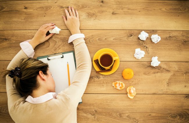 Exhausted Woman With Poor Work Life Balance Resting Head on Table | Vitacost.com/blog