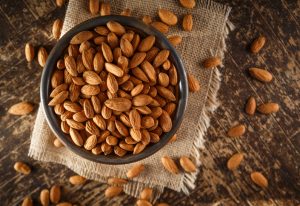 Bowl of Mineral-Rich Almonds on Burlap Placemat on Wooden Table | Vitacost.com/blog