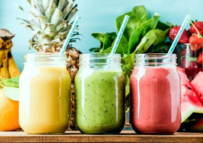 Yellow, green and pink smoothies in a row on wood | Vitacost.com/blog