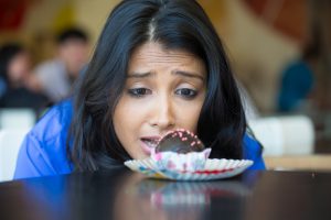 Woman Staring at Chocolate Dessert Looking to Curb Craving | Vitacost.com/Blog