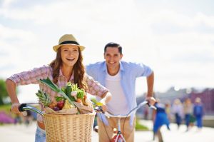 Couple Following a Vegetarian Diet for its Environmental Benefits Riding Bicycles in Park | Vitacost.com/blog