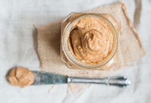 Glass Jar and Knife With Almond Butter Representing Possible Way to Address Low Magnesium | Vitacost.com/blog