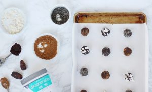 Baking Sheet of Power Balls on Marble Counter with Bowls of Superfoods| Vitacost.com/blog