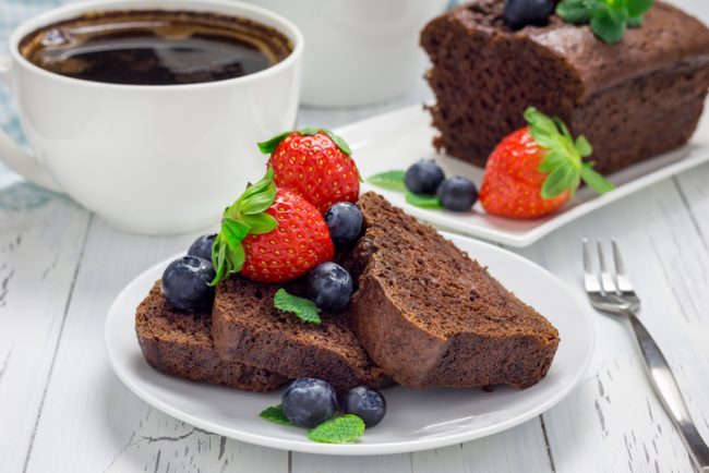 Gluten-Free Chocolate Quick Bread Recipe  Slices of Gluten-Free Chocolate Quick Bread on White Plate with Berries | Vitacost.com/blog