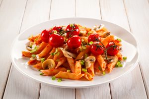 Red Lentil Pasta on White Plate with Cherry Tomatoes & Mushrooms | Vitacost.com/blog