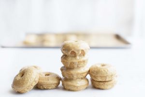 Stack of Mini Homemade Peanut Butter Donuts with Glaze on White Table #recipe | Vitacost.com/blog