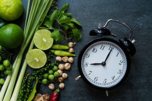 Heart Healthy Vegetables and Fruits Beside a Clock on Slate Background | Vitacost.com/blog