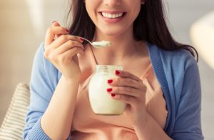 Woman Eating Low-Fat Yogurt to Protect Kidney Health | Vitacost.com/blog