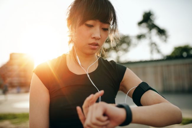 Young Woman Who Appears Bored with Workout Routine Switching Music | Vitacost.com/Blog