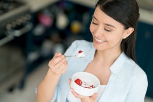 Woman Eating Healthy Breakfast to Help Improve Digestion | Vitacost.com/blog