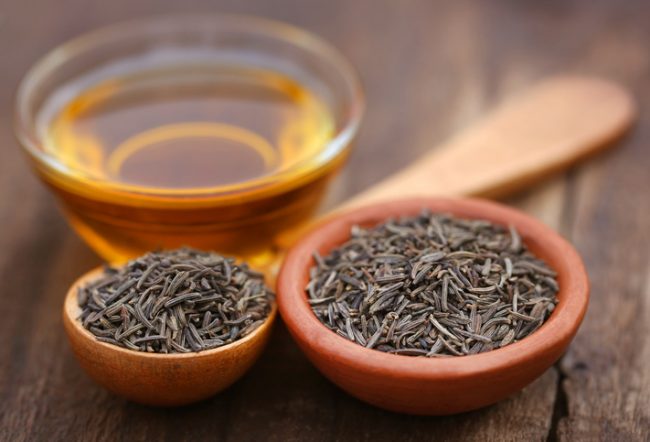 Black Cumin Seeds in Spoons Beside Bowl of Oil on Wooden Table | Vitacost.com/blog