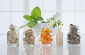 Assortment of Women's Multivitamins in Glass Jars on Clear Table | Vitacost.com/blog