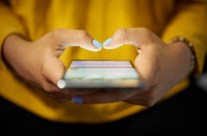 Woman in Need of Digital Detox Gripping Smartphone in Her Hands | Vitacost.com/blog