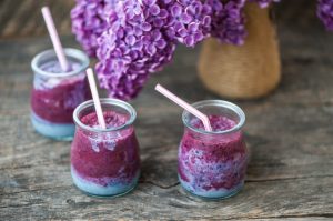 3 Small Blueberry Smoothies (for babies) on Wood Table with Purple Flower | vitacost.com/blog