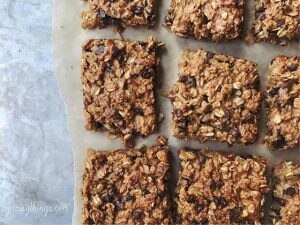 9 Homemade Chocolate Chip, Coconut & Oat Granola Bars on Parchment Paper #recipe | Vitacost.com/blog