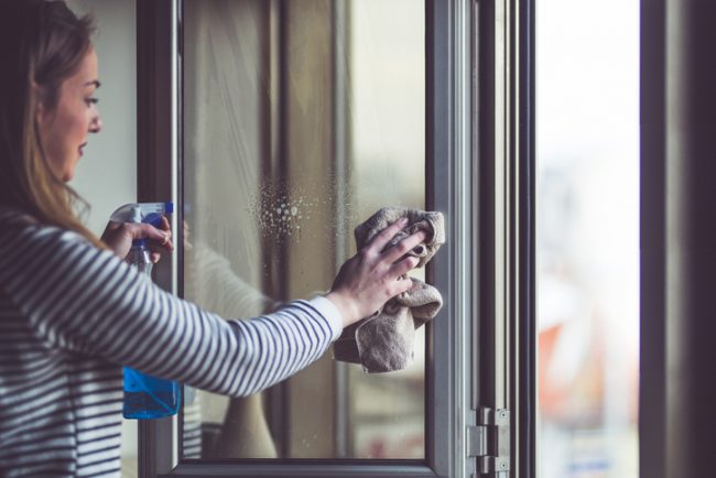 5 DIY Natural Household Cleaners Woman Cleaning Window with Homemade Essential Oil Cleaner | Vitacost.com/Blog