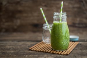 Green Macadamia Moringa Smoothie with Straw on Rustic Wood | Vitacost.com/blog