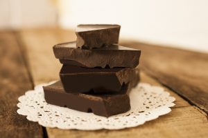 4 Pieces of Homemade Paleo Chocolate Bars Stacked on Doily #recipe | Vitacost.com/blog