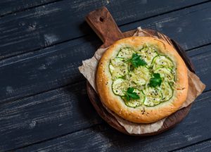 Nut- & Dairy-Free Pesto Pita Pizza on Rustic Cutting Board | Vitacost.com/blog
