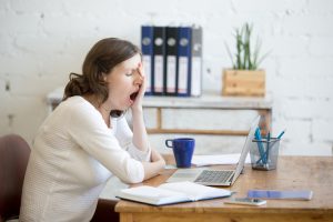 Sleepy Woman Working at Desk Thinks She Has Adrenal Fatigue | Vitacost.com/blog