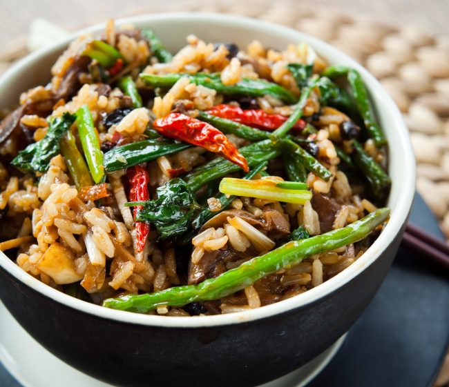 Black Buddha Bowl Full of Spring Veggies & Rice on Black Plate #recipe | Vitacost.com/blog