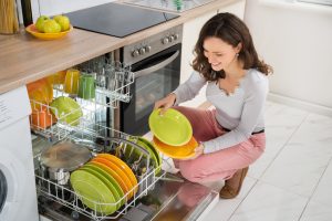 Woman Arranging Plates in Dishwasher | Vitacost.com/Blog