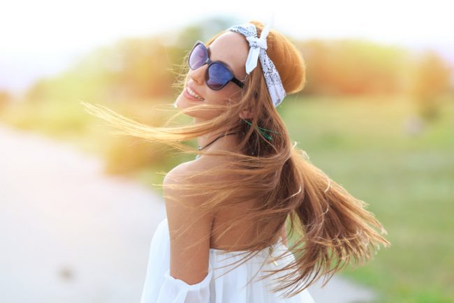 Woman Outdoors Flipping Healthy Hair | Vitacost.com/Blog