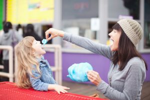 Mother Feeding Daughter Blue Cotton Candy at Theme Park | Vitacost.com/blog