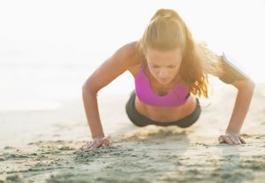 Woman Doing Pushups on the Beach | Vitacost.com/Blog