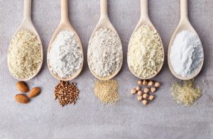 A Row of Five Wooden Spoons Filled with Gluten-Free Ingredients | Vitacost.com/blog