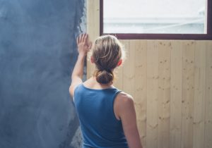 Woman Facing Wall Being Renovated Wondering if Her Home Contains Asbestos | Vitacost.com/blog