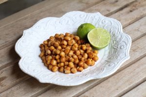 Roasted Chickpeas with Lime on White Plate on Wood Table | Vitacost.com/blog