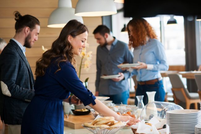 Food Etiquette Tips: Dos & Don’ts for Gluten-Free Eating Woman Following a Gluten-Free Diet Practicing Good Food Etiquette Tips at Party Buffet Table | Vitacost.com/blog