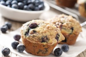 2 Gluten-Free Blueberry Protein Muffins on White Napkin with Fresh Berries #recipe | Vitacost.com/blog